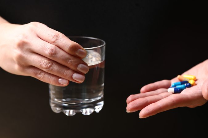 A patient receiving medication and water for Drug De Addiction at a professional Drug Rehab Mumbai facility.